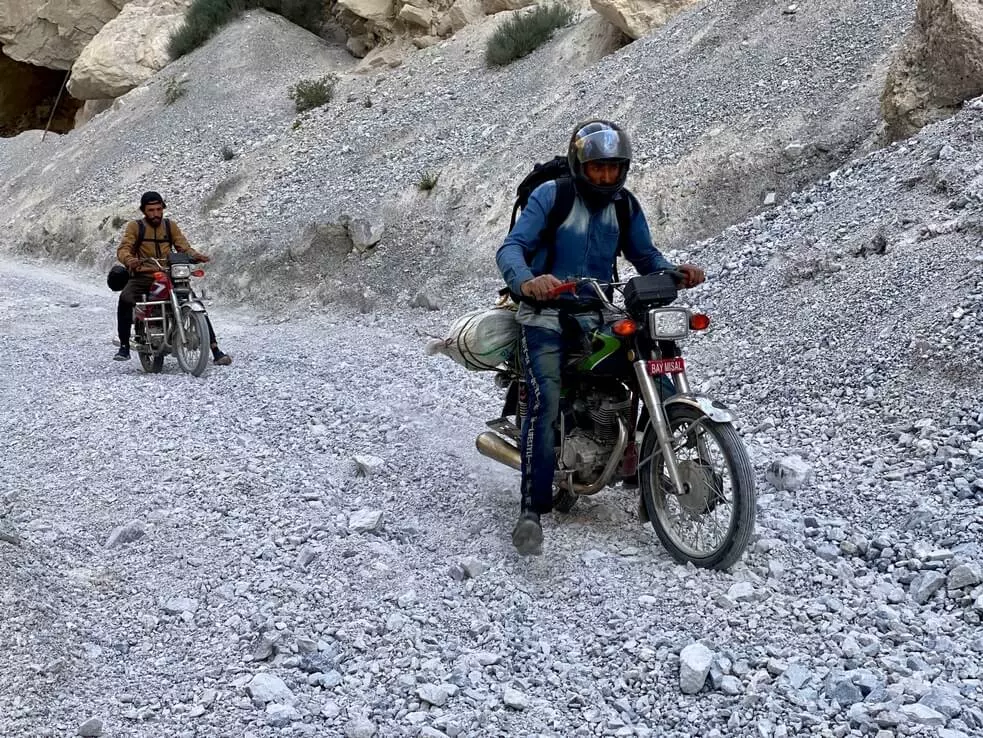 Locals carefully overcome gravel landslides